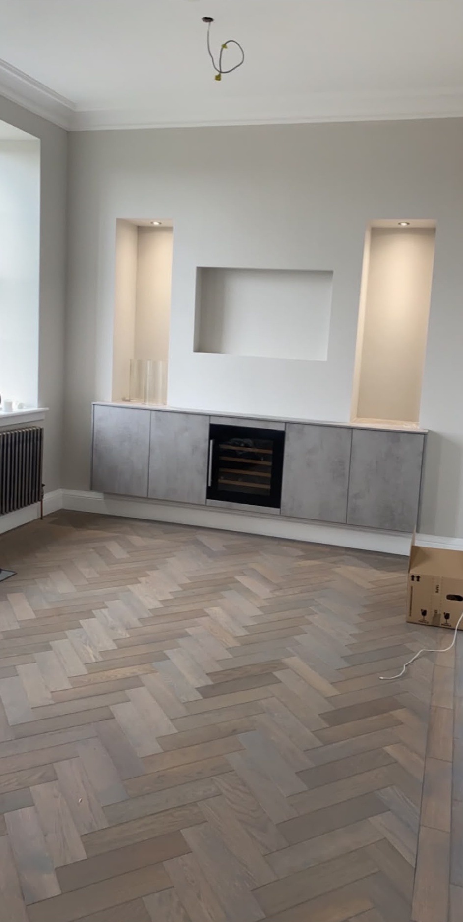 Living room media wall with plastered recessed alcoves and downlights in a Glasgow home